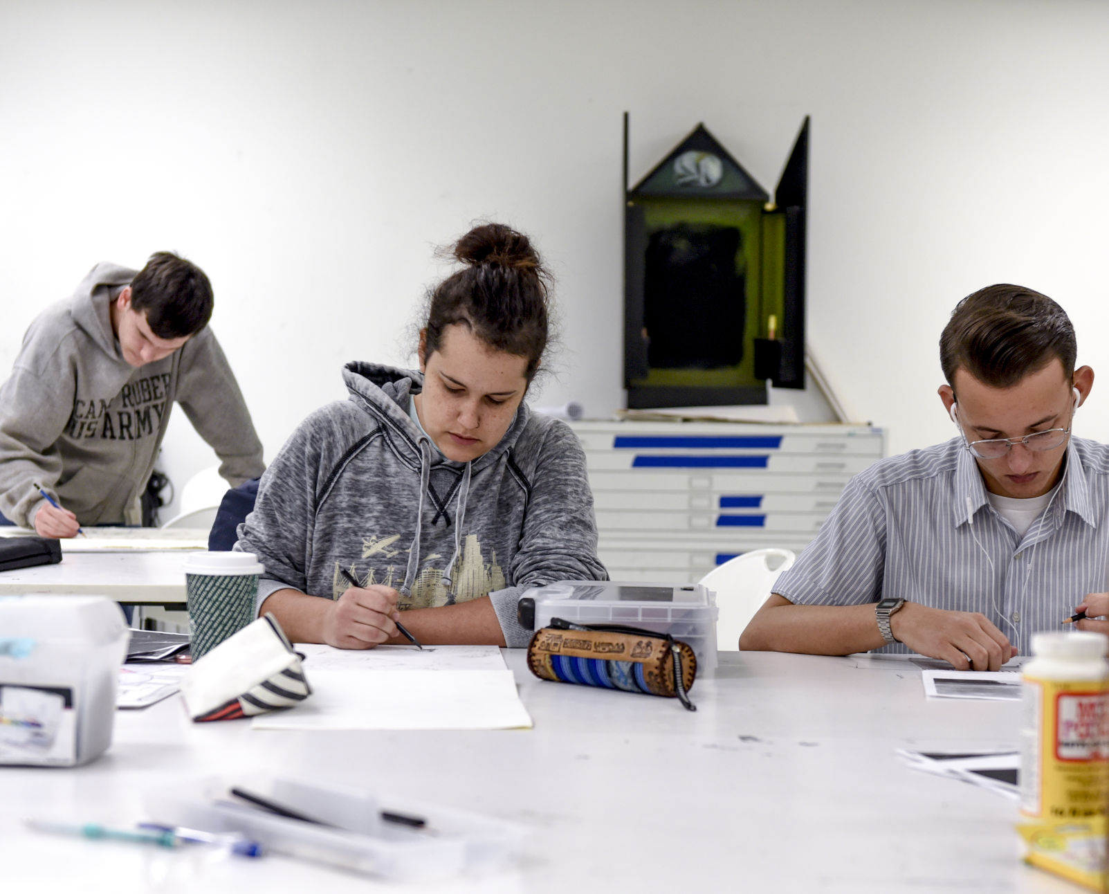 Nick Melchert, Abby Deason and Brett Henry work during art class
